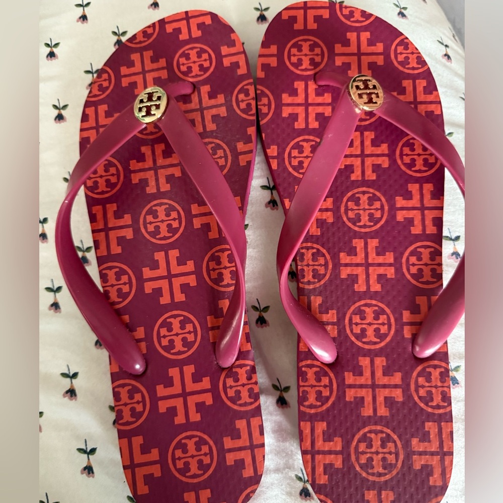 Tory Burch Red and Orange Patterned Flip Flops. more magenta/burgundy